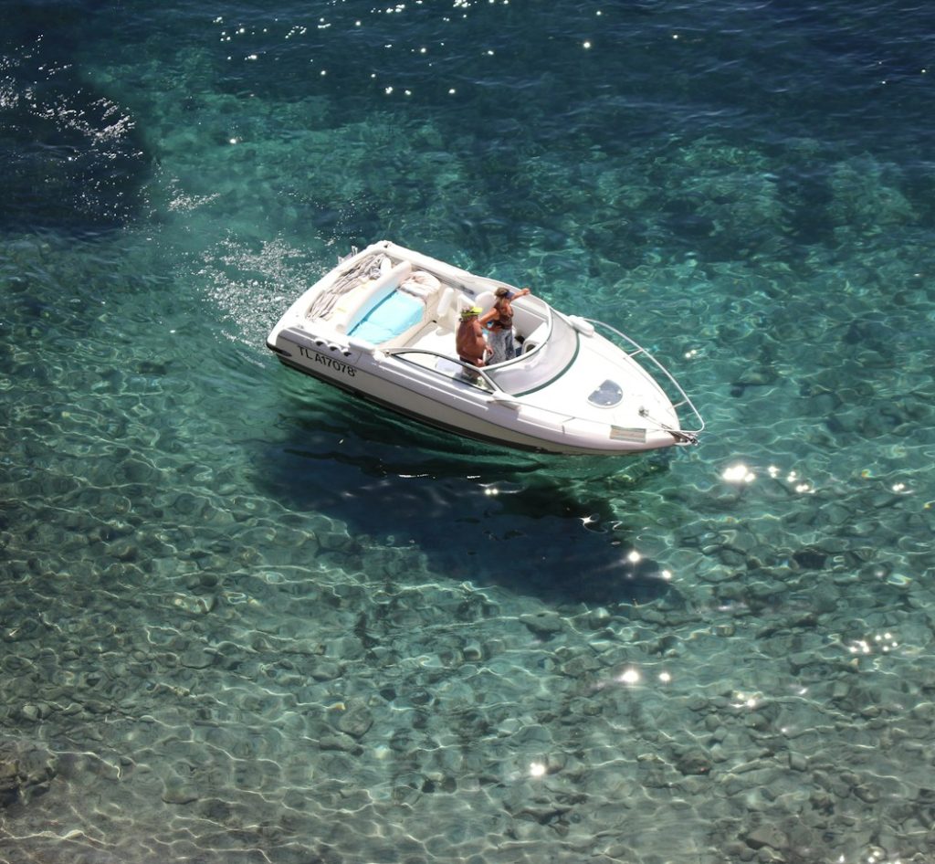 two people riding white boat